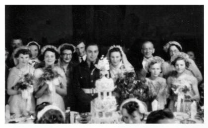 The ornate wedding cake and the bridal group 1954.