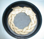 Lift the dough wreath into the tin.