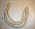 Roll 3 pieces of dough into long sausages fairly even in size.