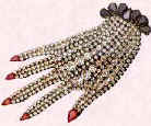 Picture of hand shaped brooch.  Costume and fashion history of jewelry.