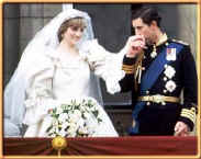 Picture of Princess Diana and Prince Charles on the balcony at Buckingham Palace as he kisses her hand on their wedding day. New romantics fashion history 1980s.