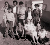 Picture of family goup outside a caravan. Costume history and fashion history 1950s.