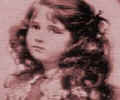 Headshot picture of Lady Elizabeth Bowes-Lyons as a child showing her with ringlets.