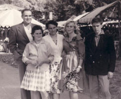 Picture of family at the fairground circa 1959. Costume history and fashion history 1950s.