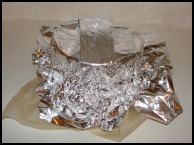 Smooth down the layers of paper and foil so they close the the basin side. This will protect your Christmas pudding from water seeping into the mix.