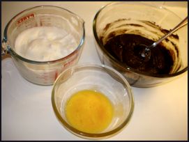 The whipped egg whites and forked yolks are ready for the final folding into the melted chocolate brownie cake mixture. 