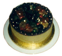 Picture of a Christmas cake decorated with various glace fruits.