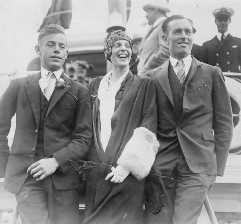 Men wearing tailored lounge suits during the 1930s in a public setting.