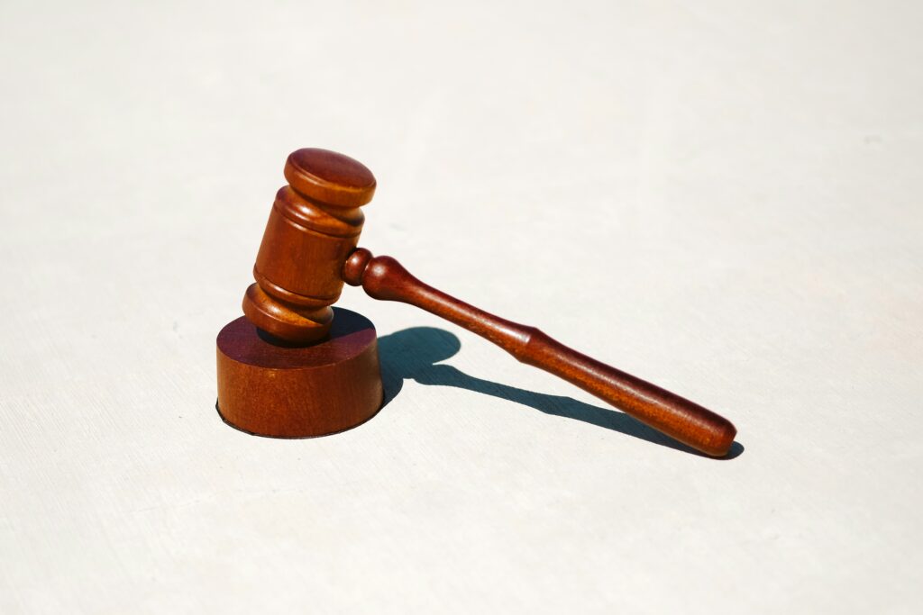 Wooden judge's gavel resting on a light surface