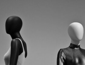 Black and white mannequins displaying glossy latex fashion