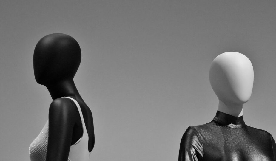 Black and white mannequins displaying glossy latex fashion