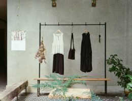 Minimalist clothing rack with black and white garments in a simple interior