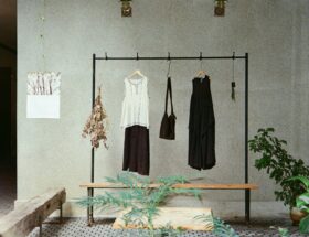 Minimalist clothing rack with black and white garments in a simple interior