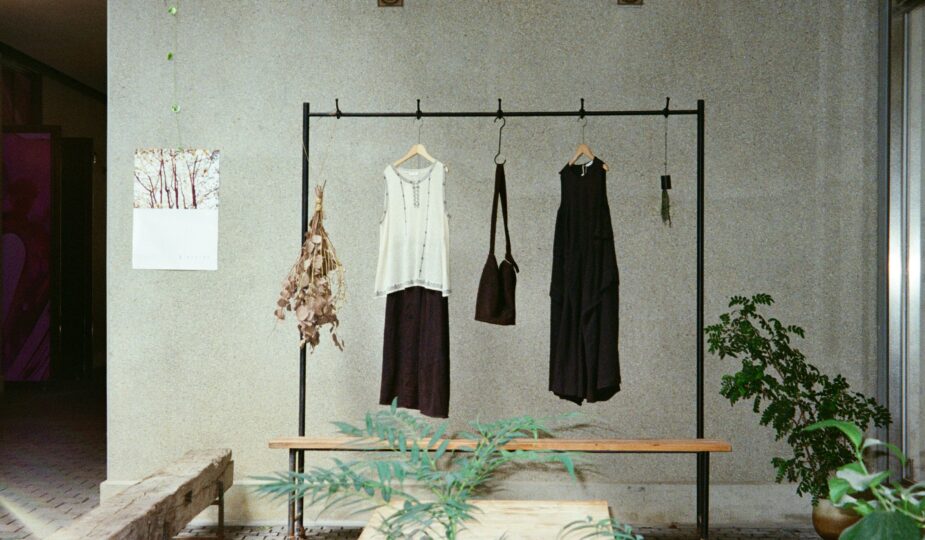 Minimalist clothing rack with black and white garments in a simple interior