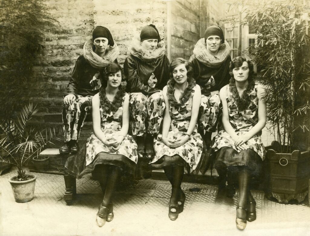 Group of women wearing 1920s dresses and period hairstyles